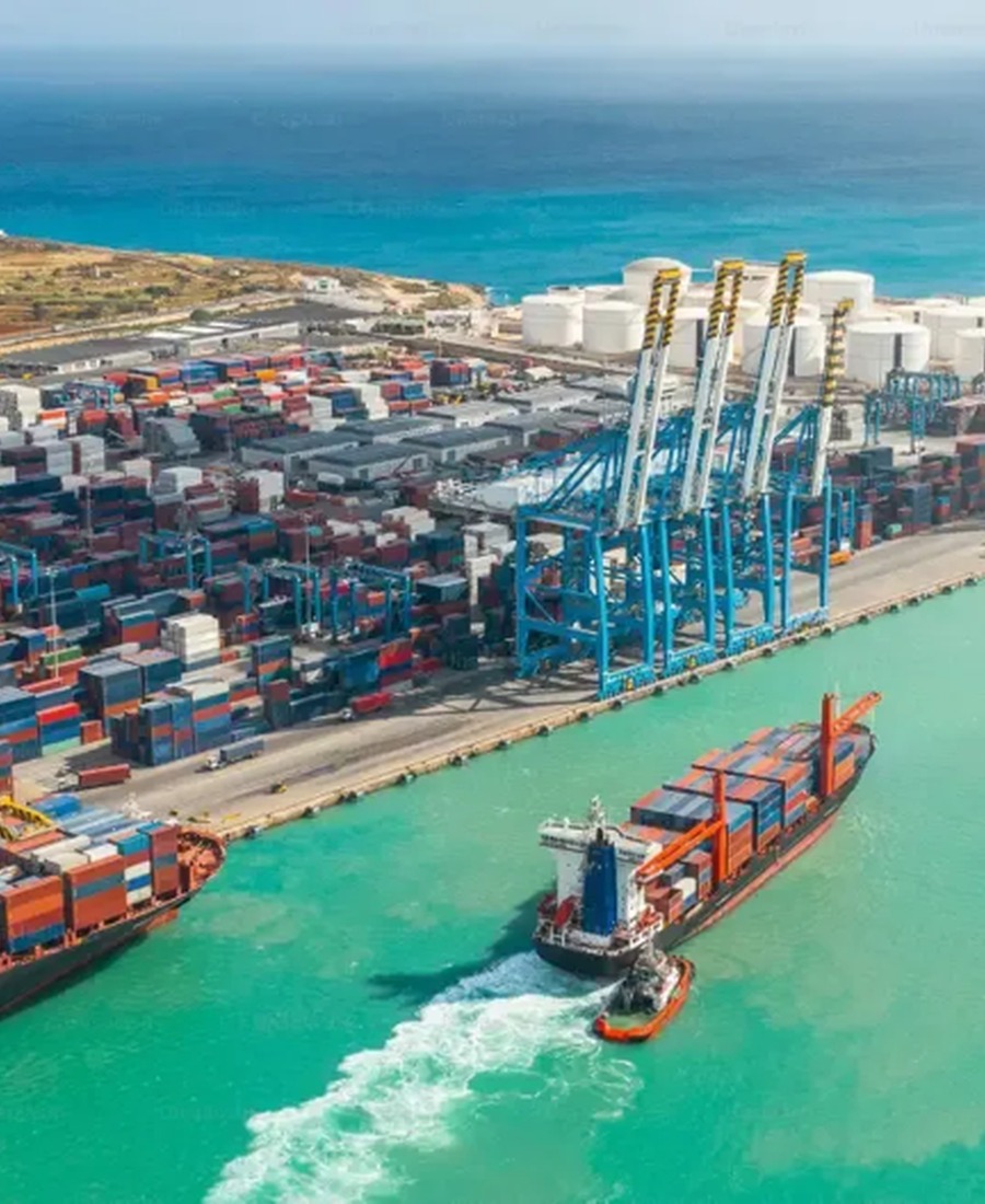 Aerial view of a container port terminal with ships and cranes